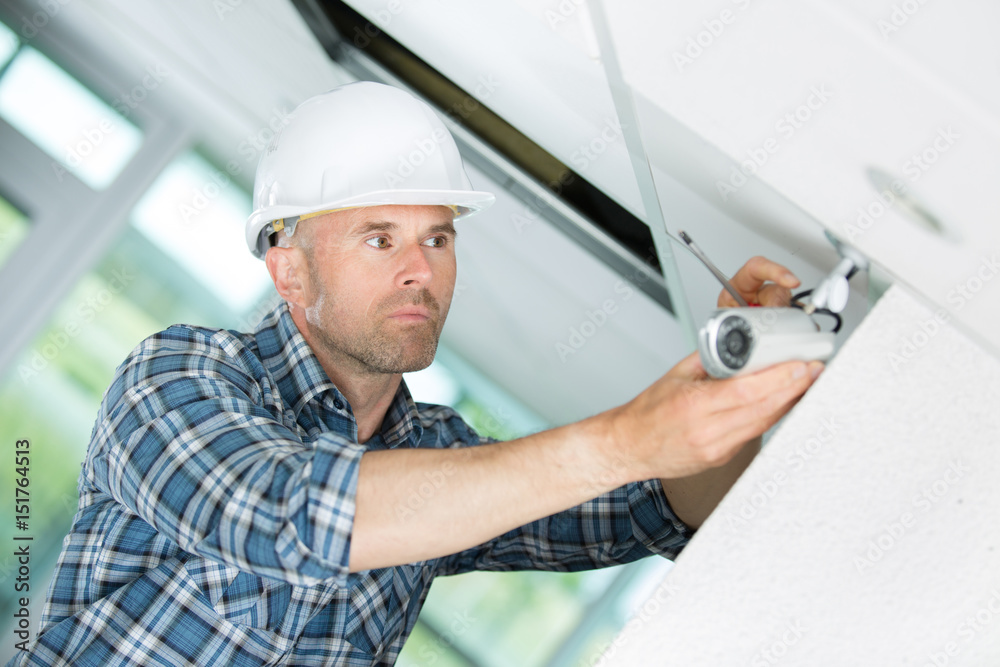 Man installing cctv camera Man installing cctv camera
