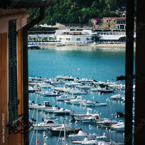 Scenic overview of white sailing boats, moored in harbour port of Lerici, Liguria, Italy. Picturesque travel destination postcard, poster.