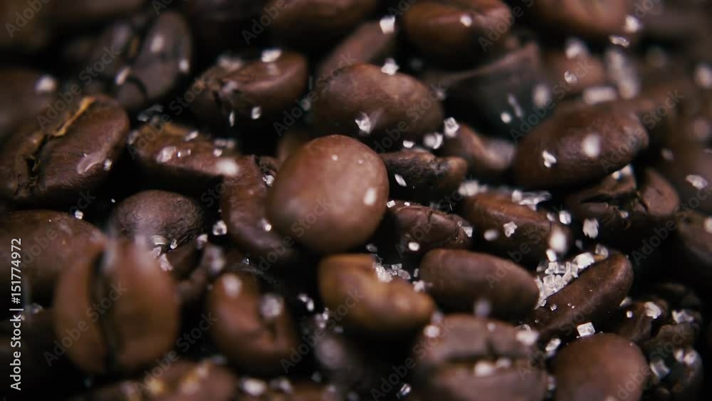 Slow mo. Fried brown coffee beans covered with crystalline sugar closeup Slow mo. Fried brown coffee beans covered with crystalline sugar closeup