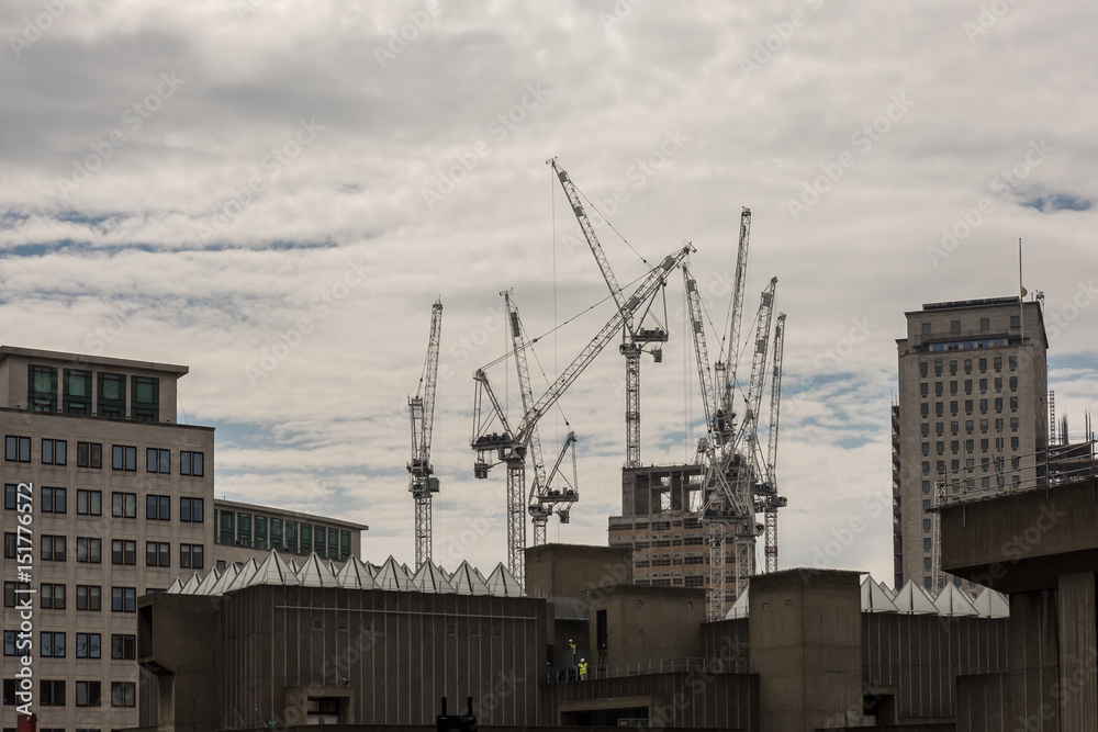 Multiple tower cranes on the skyline of the River Thames South Bank