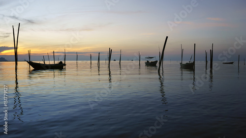 View in Time of sunrise on a beach of a fishing village