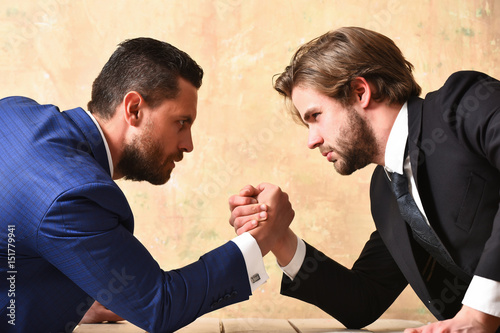 Conflict. Businessmen arm wrestling photo