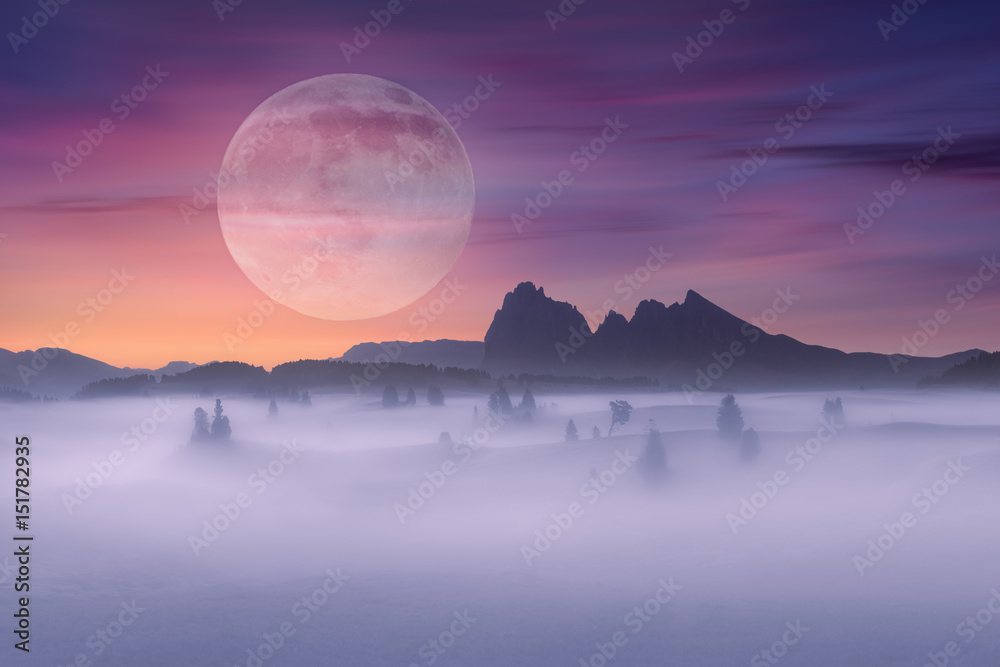 Full moon on idyllic fantasy scenery and misty scene