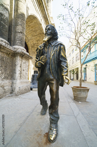 Iron statue of homeless man with beard and in peeled clothes on the central square of Havana