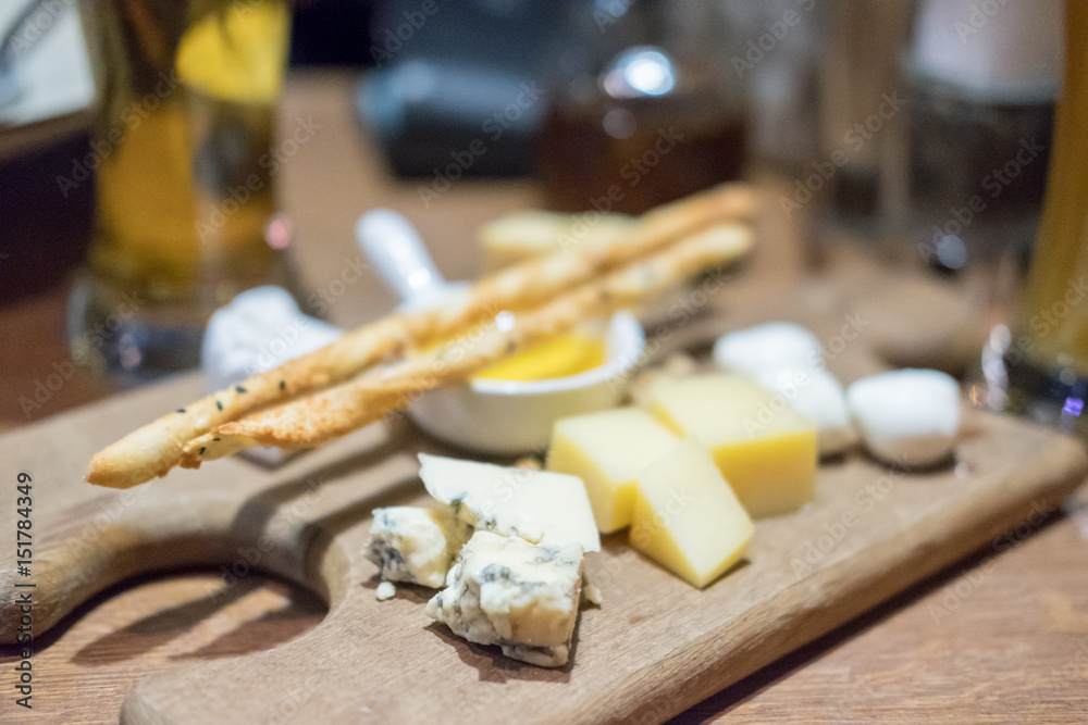 Set of various cheese on plate, with blur background Set of various cheese on plate, with blur background