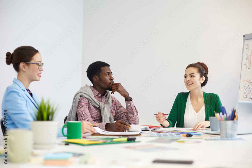 Employees consulting about points of presentation Employees consulting about points of presentation