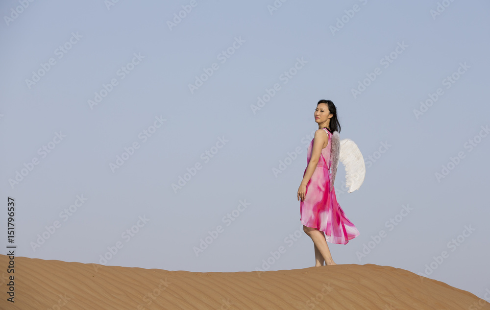 young woman with angel wings in a desert young woman with angel wings in a desert