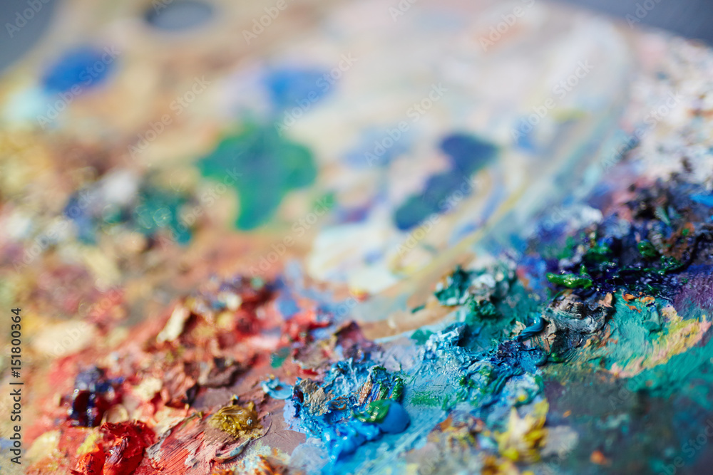 Fototapeta premium Closeup macro shot of colorful oil paint mix on artists palette, selective focus