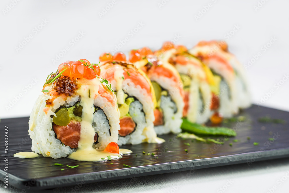 Close-up of japanese traditional rolls and sushi on a black stone plate Close-up of japanese traditional rolls and sushi on a black stone plate