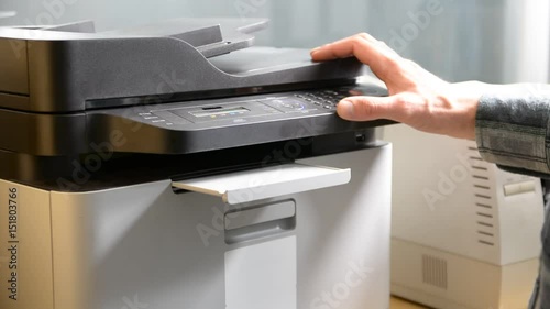 Male hand printing document on printer or fax or scanner, then retrieving paper sheet photo