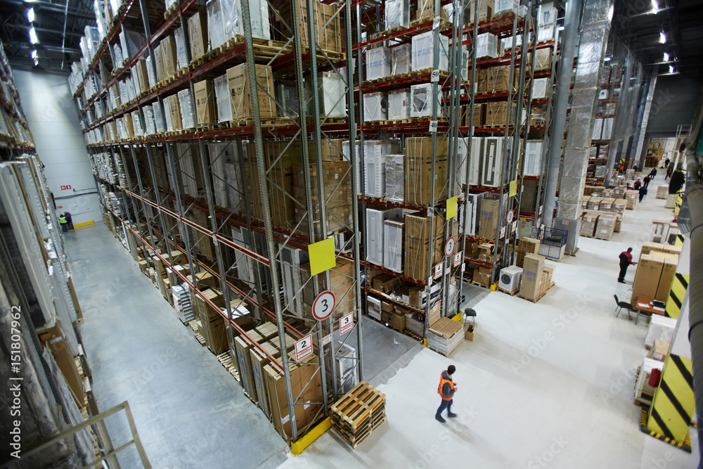 Large factory or warehouse with goods and workers - obrazy, fototapety, plakaty 