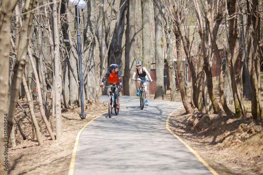 Cyclists on road in park Cyclists on road in park