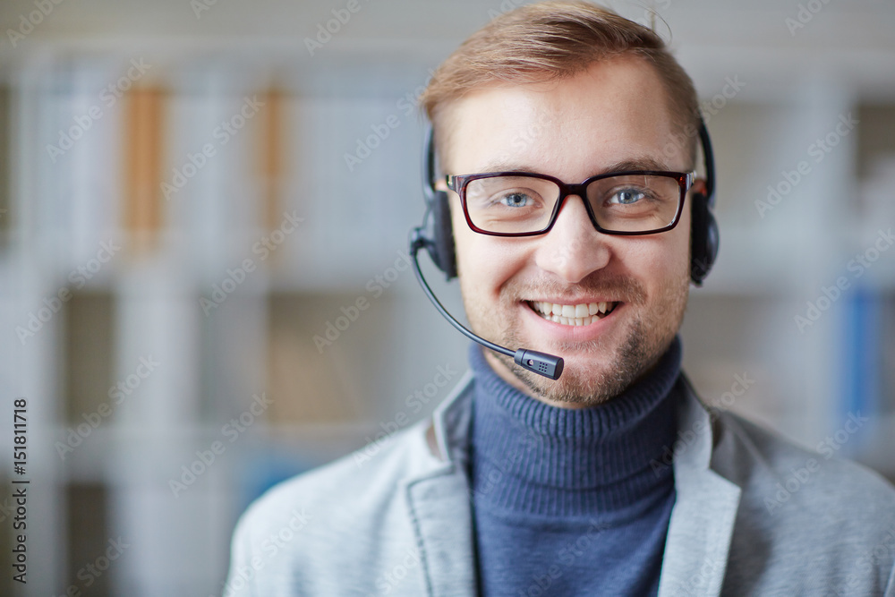Helpdesk consultant with headset looking at camera Helpdesk consultant with headset looking at camera