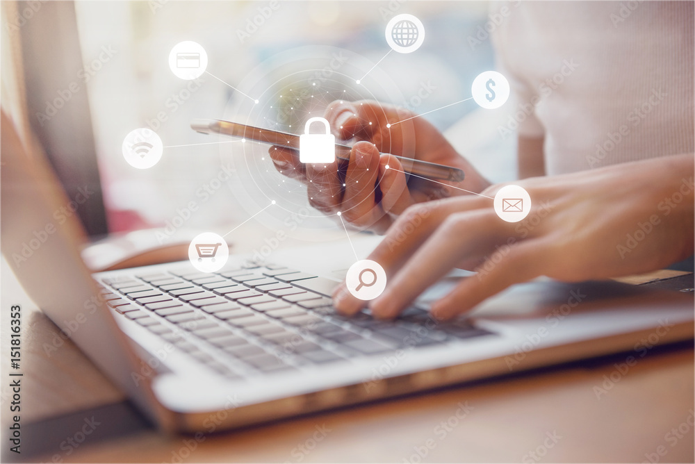© oatawa - Woman using smartphone and laptop with icon graphic Cyber security network of connected devices and personal data security