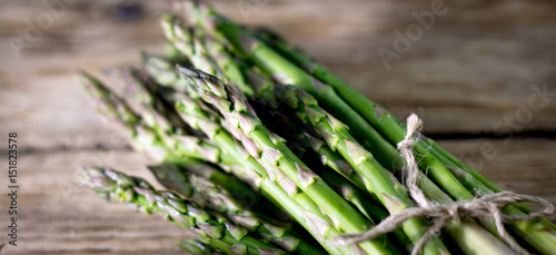 Brunch of Fresh Asparagus on vintage wooden background. place for text