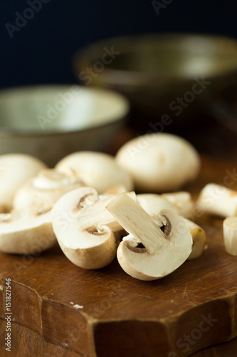 Champignon mushrooms on the wooden table. Selective focus
