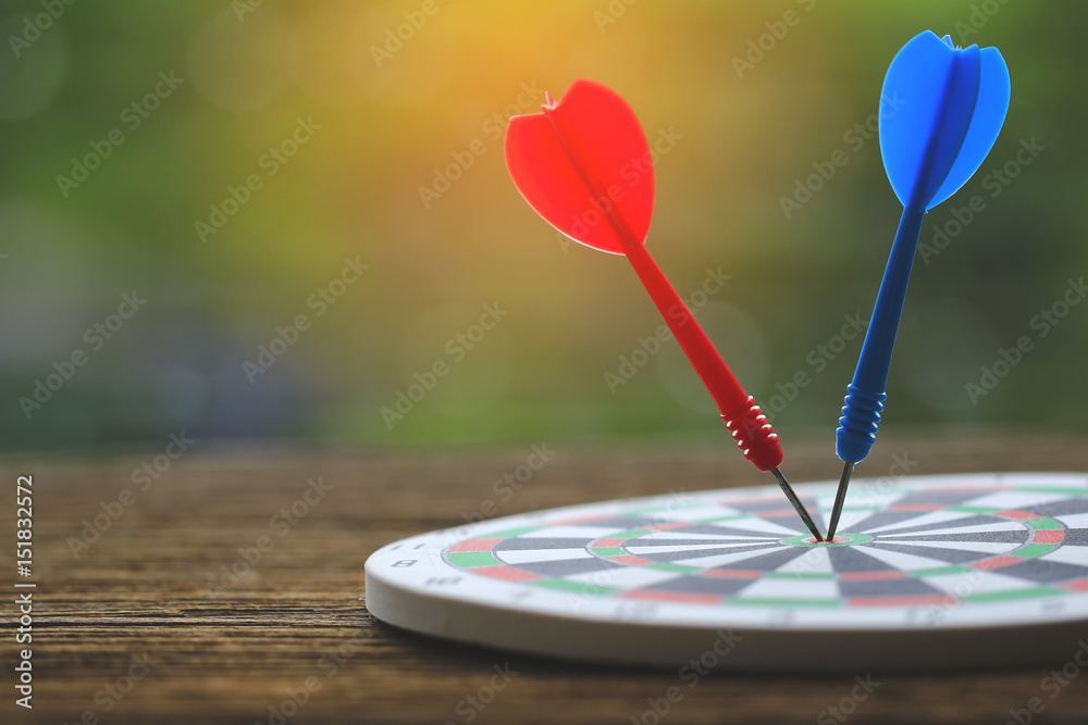 Stock Photo - two darts hit the dead centre of target Stock Photo - two darts hit the dead centre of target