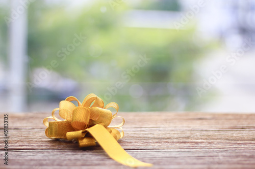 Stock Photo - Golden Cross ribbon bow on Texture backgronud photo