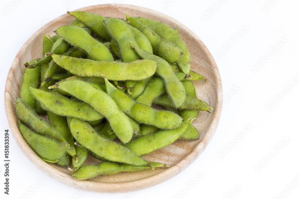 Green soybean (Vegetable soybean) boiled in wooden plate on white Green soybean (Vegetable soybean) boiled in wooden plate on white