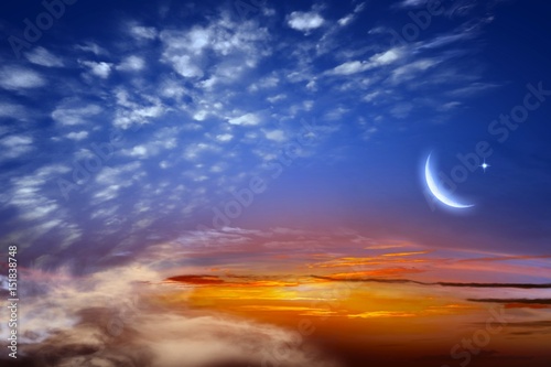 Red sunset and moon .Eid Mubarak background  .  Against the background of clouds . beautiful sky .  
