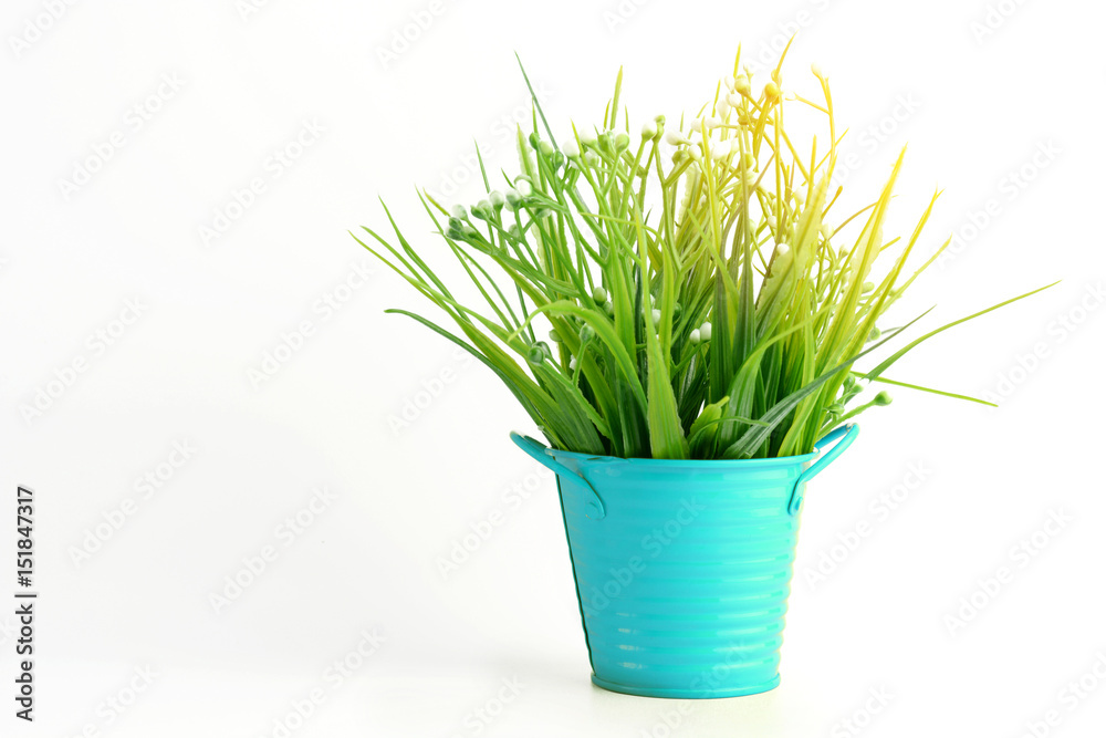 Grass plastic in light blue pot color with sunshine on white backgroun Grass plastic in light blue pot color with sunshine on white backgroun