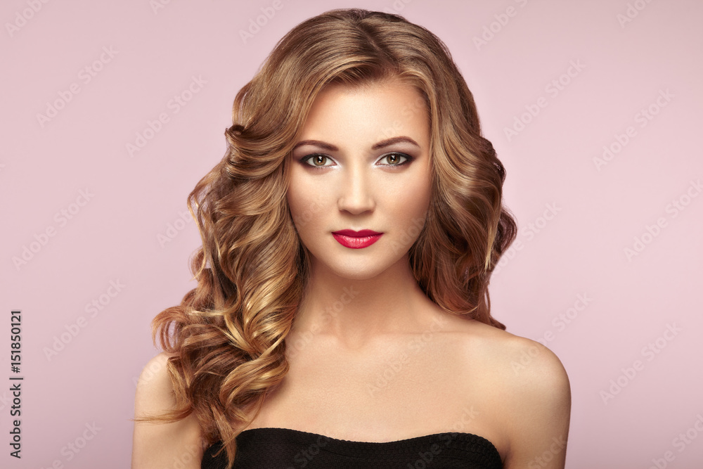 Blonde woman with long and volume shiny wavy hair . Beautiful model with curly hairstyle. Perfect make-up. Beauty style model Blonde woman with long and volume shiny wavy hair . Beautiful model with curly hairstyle. Perfect make-up. Beauty style model