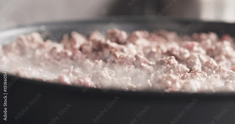 Slide shot of roasting minced beef in a pan, 4k 60fps prores footage Slide shot of roasting minced beef in a pan, 4k 60fps prores footage