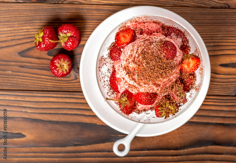 top view of dessert strawberry pink vanilla ice cream scoops with sprinkled chocolate and fresh strawberry on wooden table top view of dessert strawberry pink vanilla ice cream scoops with sprinkled chocolate and fresh strawberry on wooden table