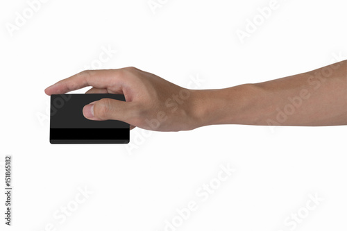 man's hand holding blank black credit card mockup with black magnetic stripe isolated with white, back side view.