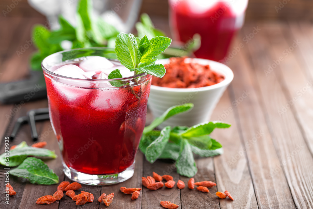 Healthy detox drink with goji berries infused in water with ice, cold refreshing beverage Healthy detox drink with goji berries infused in water with ice, cold refreshing beverage