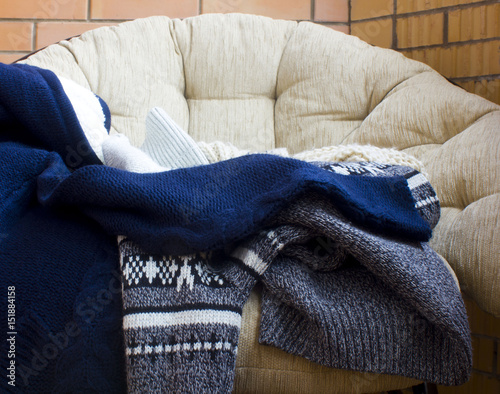 warm clothes , a sweater on the chair