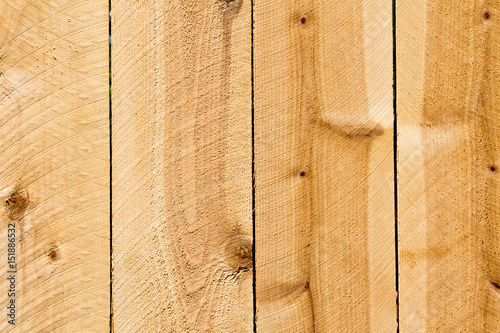 Planks of a new cedar privacy fence