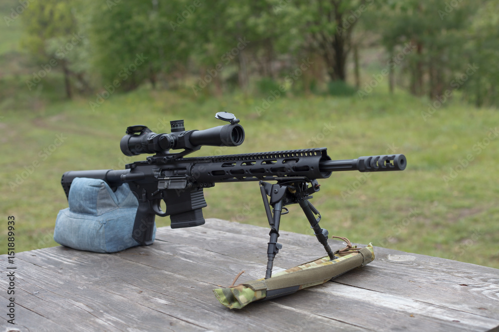 Sniper rifle. Horizontally. On the table in the forest. Sniper rifle. Horizontally. On the table in the forest.