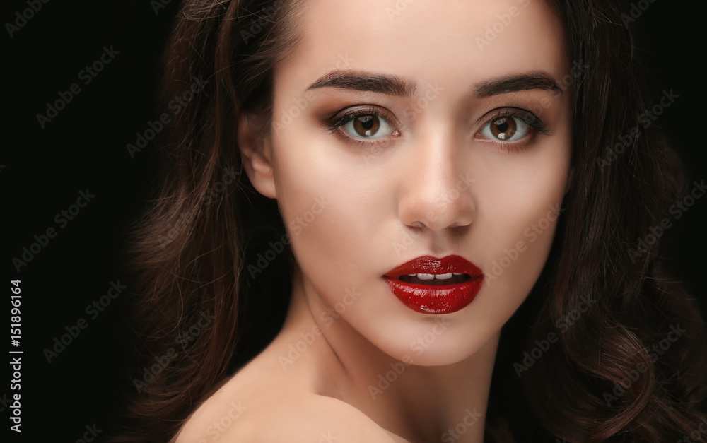 Portrait of beautiful woman with red lips on dark background Portrait of beautiful woman with red lips on dark background