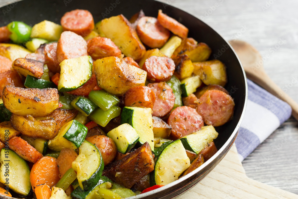 One pot sausage with colorful vegetables on cutting board One pot sausage with colorful vegetables on cutting board
