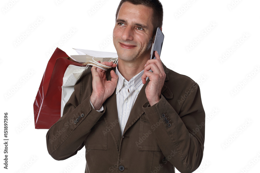 Man shopping. Male holding shopping bags and using cellphone. Online shopping concept. Man shopping. Male holding shopping bags and using cellphone. Online shopping concept.