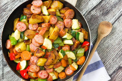 One pot sausage with colorful vegetables, top view