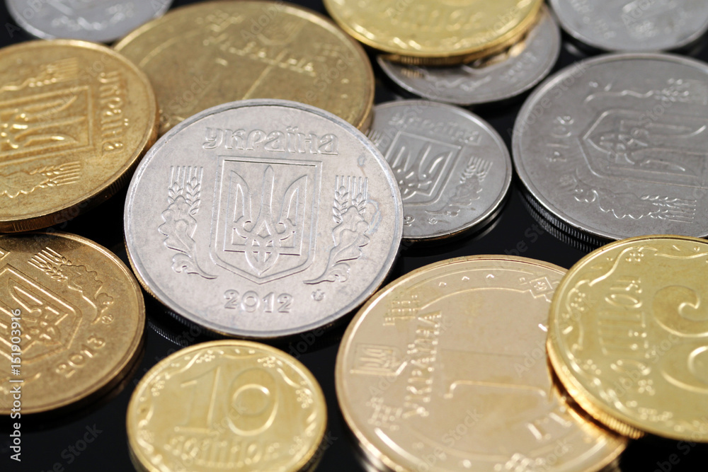 A close up image of assorted Ukrainian coins on a black background A close up image of assorted Ukrainian coins on a black background
