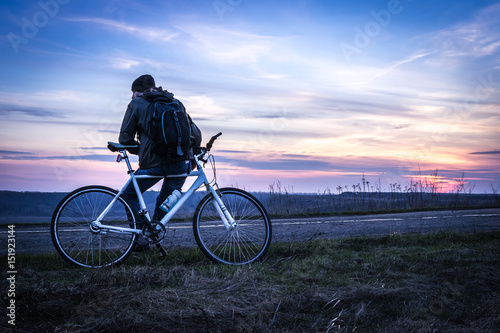Fototapeta Naklejka Na Ścianę i Meble -  Man with bicycle at sunset