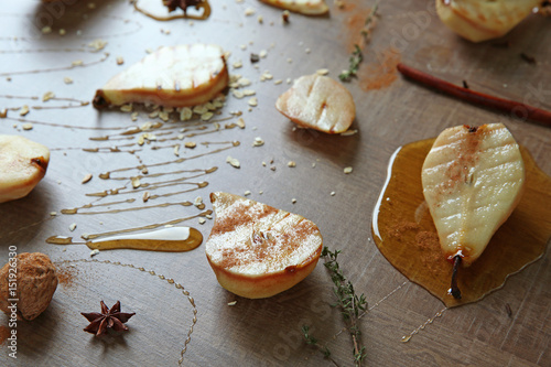 Fototapeta Naklejka Na Ścianę i Meble -  Tasty pears with honey sauce on wooden background