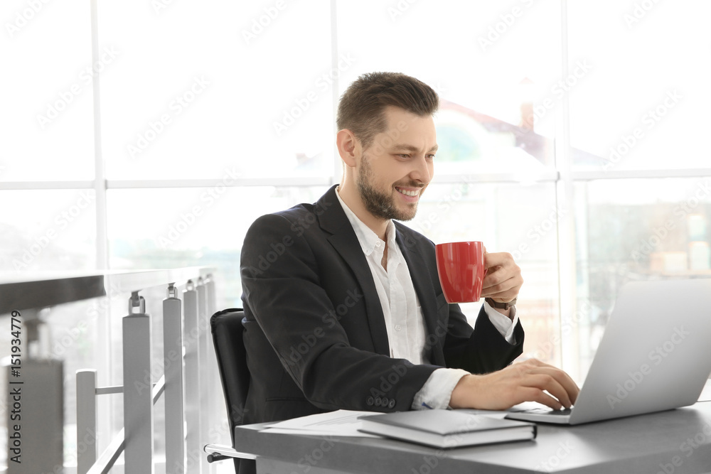 Young businessman working with laptop in office Young businessman working with laptop in office