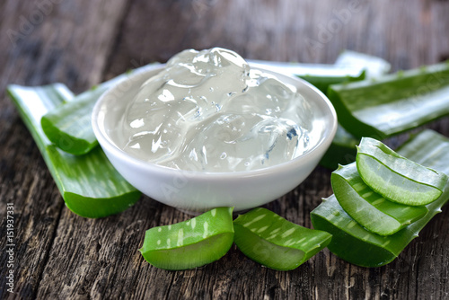 aloe vera gel in bowl with on wooden table