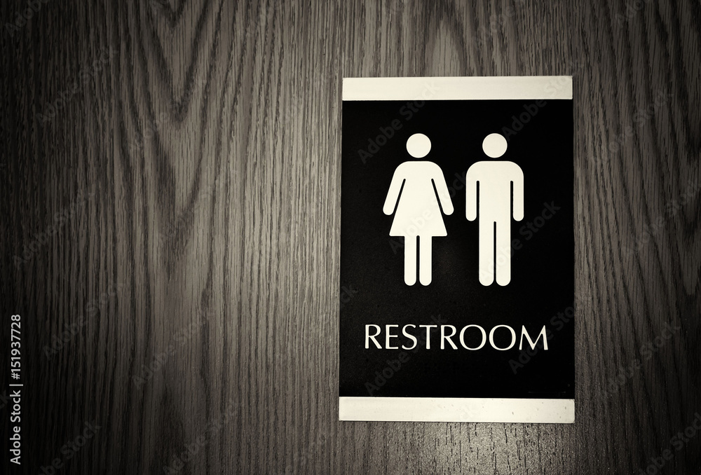horizontal black and white image of a unisex bathroom sign for men and ...