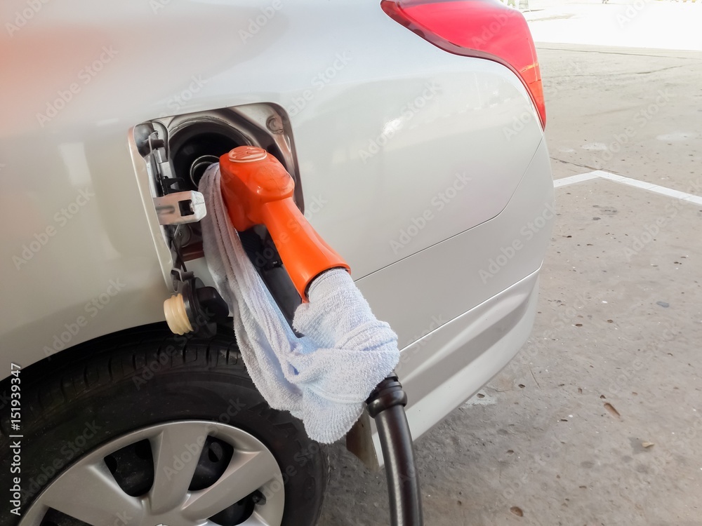 Workers fueling cars Workers fueling cars