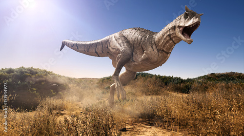 A 3d rendering of Carnotaurus charging through a field. © Herschel Hoffmeyer