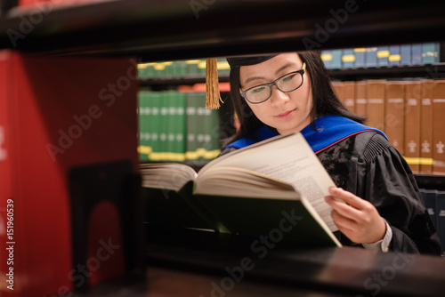 PhD student reading a book in library