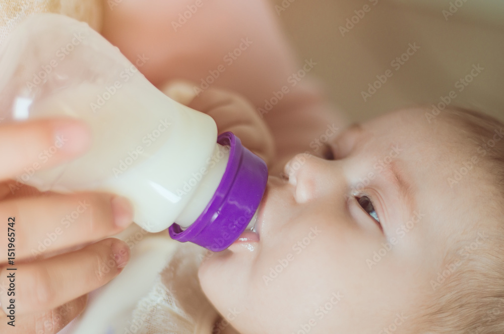 A young mother, feeding the child A young mother, feeding the child