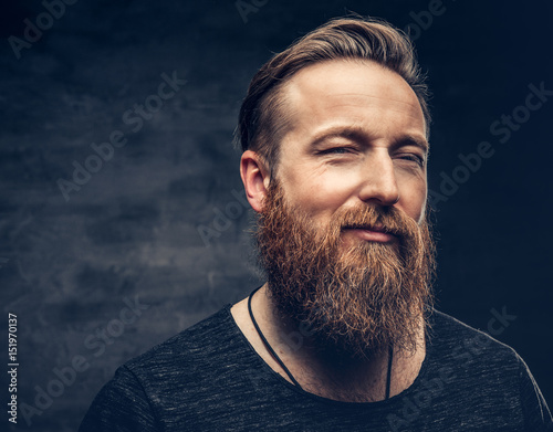 Redhead bearded male over grey background. photo