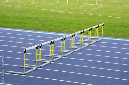 Hurdles on empty running track photo