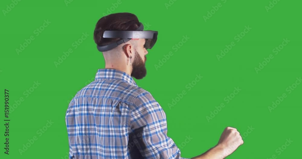 Young adult Caucasian male using holographic augmented reality glasses. Green screen chroma key. 4K UHD RAW edited footage Young adult Caucasian male using holographic augmented reality glasses. Green screen chroma key. 4K UHD RAW edited footage